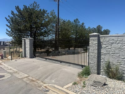 Black steel automated sliding driveway gate — view 4.
